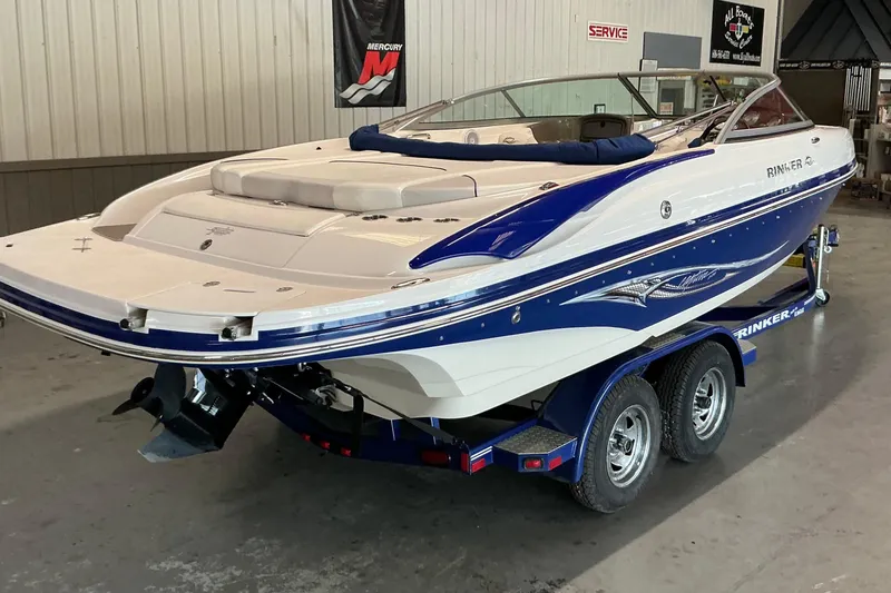 Slide: The Image of 2008 Rinker 226 Captiva Bowrider boat on trailer in indoor showroom. - 8