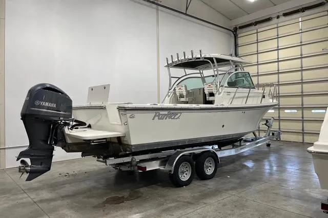 The Image of 2016 Parker 2510 XL Walkaround boat with Yamaha outboard in a garage. - 0