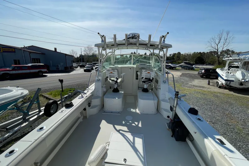 Slide: The Image of 2016 Parker 2510 XL Walkaround boat, spacious deck, equipped for fishing, parked outdoors. - 11