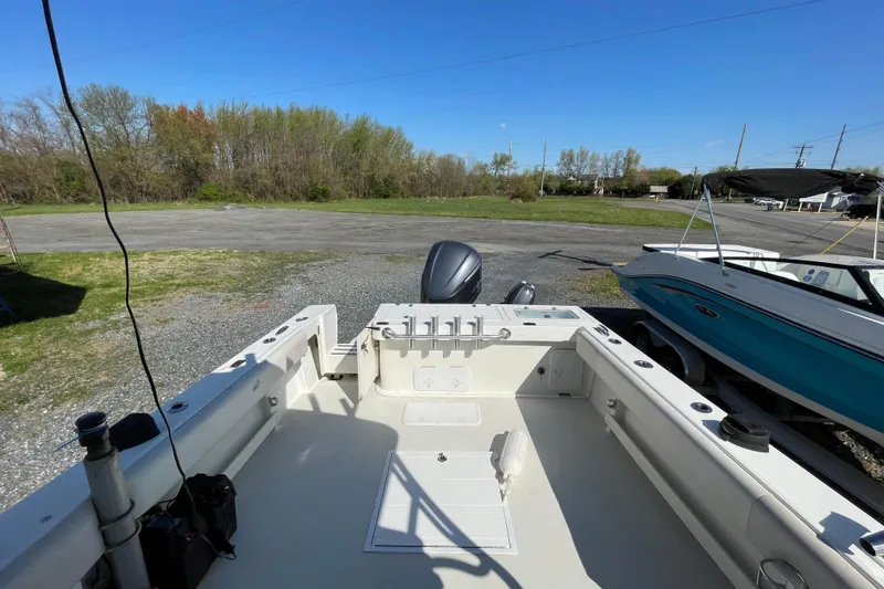 Slide: The Image of 2016 Parker 2510 XL Walkaround boat on trailer, outdoor setting, clear sky. - 13