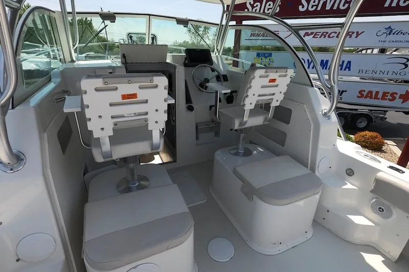 Slide: The Image of 2016 Parker 2510 XL Walkaround boat interior with helm and seating area. - 5