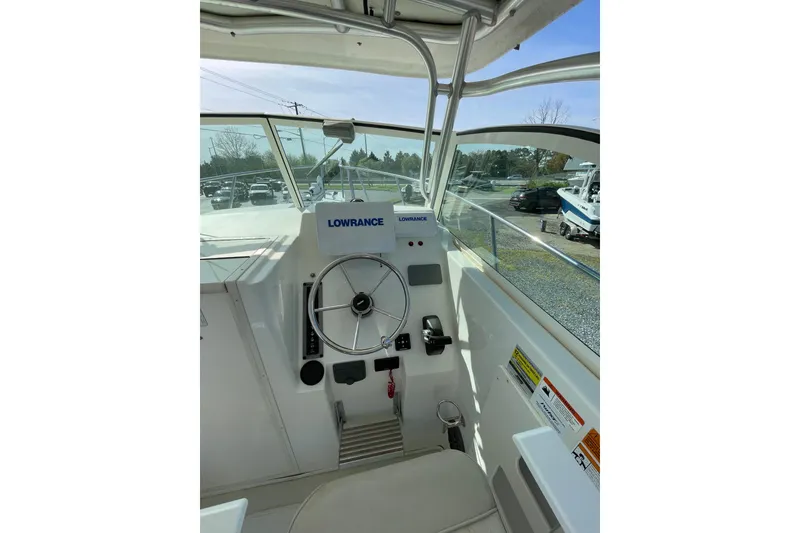 Slide: The Image of 2016 Parker 2510 XL Walkaround boat helm with Lowrance navigation system. - 6