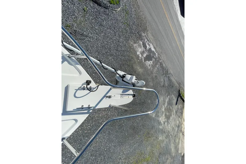 Slide: The Image of 2016 Parker 2510 XL Walkaround boat bow with anchor, viewed from above on gravel surface. - 9