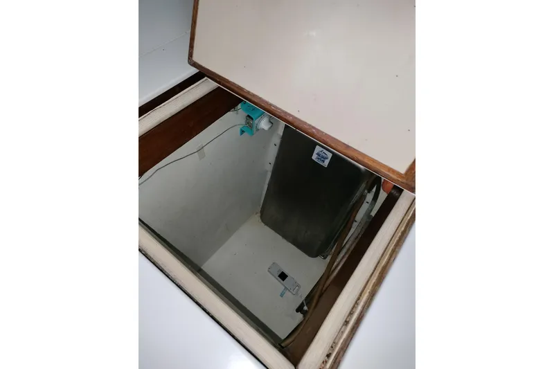 Slide: The Image of Open hatch on 1983 Durbeck 50 boat, revealing storage compartment. - 10