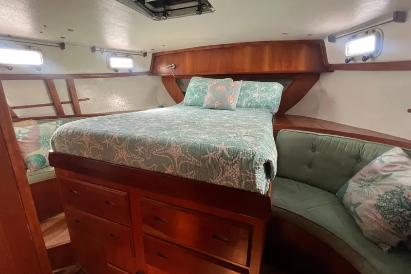 Slide: The Image of Cozy cabin interior of 1983 Durbeck 50 yacht with starfish-themed bedding. - 15