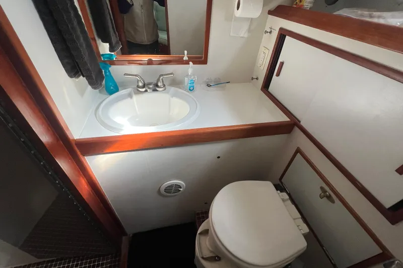Slide: The Image of Compact bathroom in a 1983 Durbeck 50 yacht, featuring sink and toilet. - 21