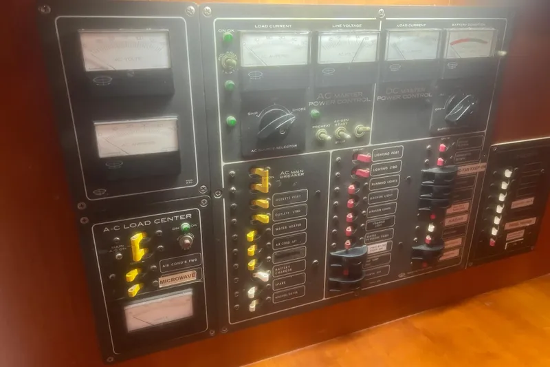Slide: The Image of Electrical control panel on a 1983 Durbeck 50 yacht, featuring various gauges and switches. - 27