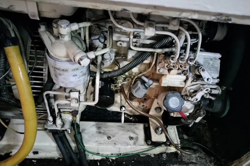 Slide: The Image of Engine compartment of a 1983 Durbeck 50, showcasing mechanical components and wiring. - 30