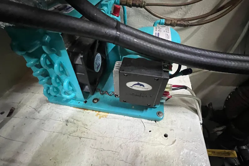 Slide: The Image of Engine compartment of a 1983 Durbeck 50, featuring mechanical components and wiring. - 33