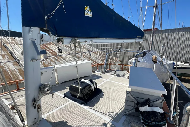 Slide: The Image of Deck of 1983 Durbeck 50 sailboat with covered equipment and clear blue sky. - 35