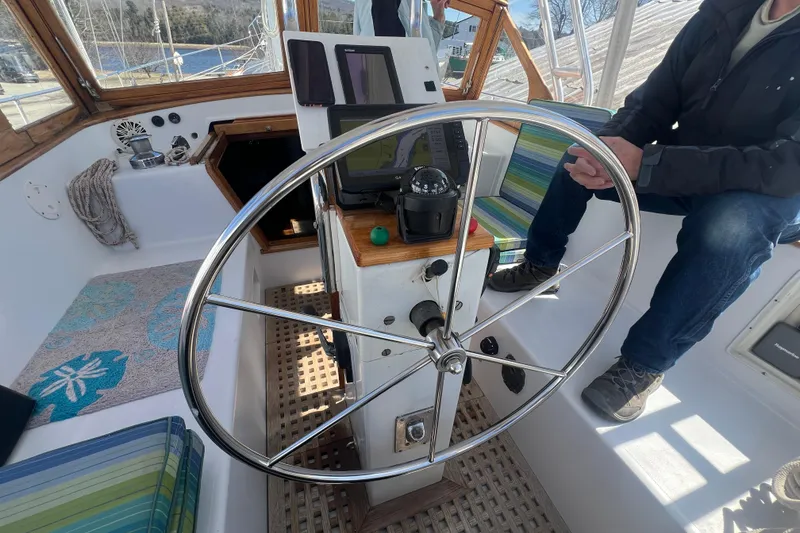 Slide: The Image of Cockpit of 1983 Durbeck 50 sailboat with steering wheel and navigation instruments. - 39