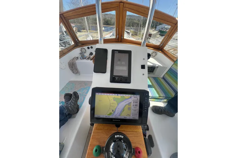 Slide: The Image of Cockpit of 1983 Durbeck 50 sailboat with navigation equipment and wooden accents. - 44
