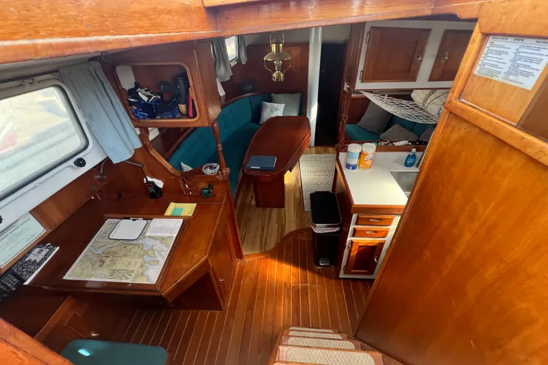 Slide: The Image of Interior of a 1983 Durbeck 50 sailboat featuring a cozy cabin with wooden furnishings. - 5