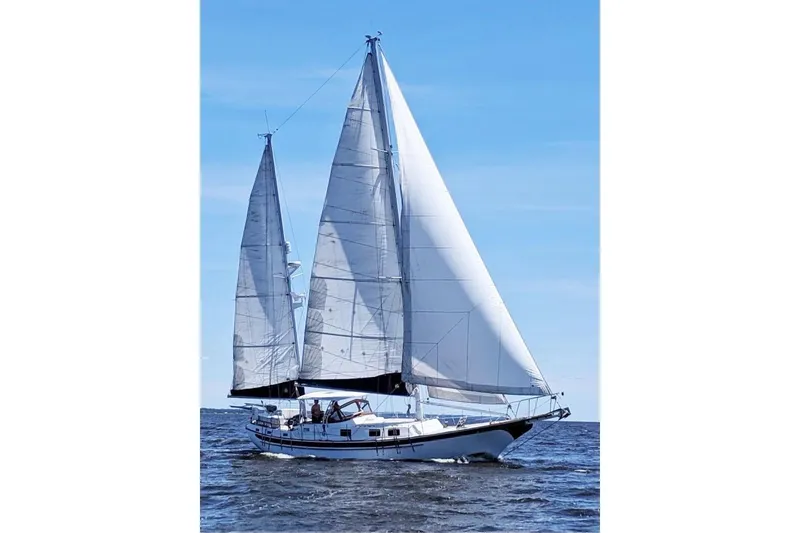 Slide: The Image of Sailing yacht Durbeck 50 from 1983 on open water under clear blue skies. - 56
