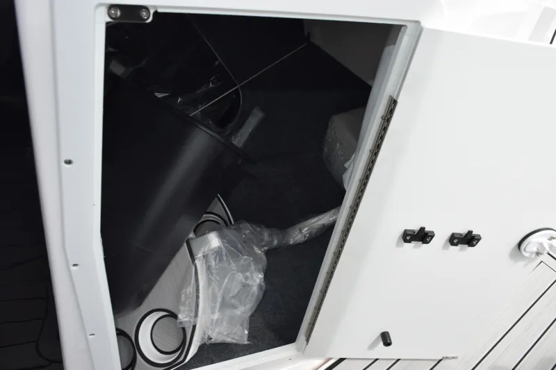 Slide: The Image of Open storage compartment in 2026 Yamaha Boats 222S, showing interior space and equipment. - 18