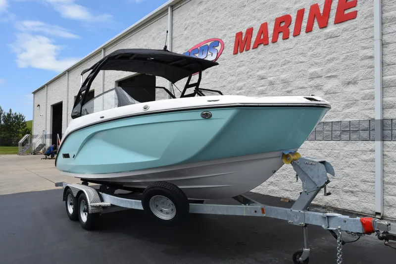 Slide: The Image of 2026 Yamaha Boats 222S on trailer outside marine dealership. - 2