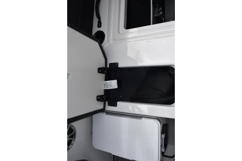 Slide: The Image of Interior storage compartment of 2026 Yamaha Boats 222S, featuring sleek design and functionality. - 22