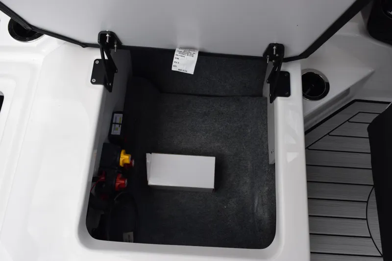 Slide: The Image of Storage compartment of 2026 Yamaha Boats 222S, featuring organized interior space. - 23