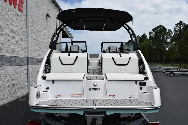 Slide: The Image of 2026 Yamaha Boats 222S, rear view, showcasing sleek design and spacious seating. - 5