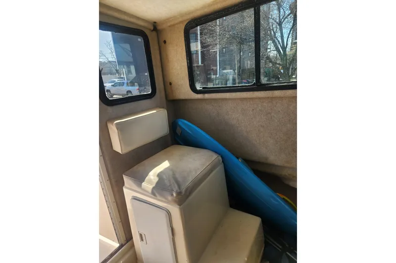 Slide: The Image of Interior of a 2000 Austin Parker 2520 Cabin boat with seating and windows. - 14