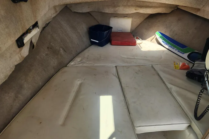 Slide: The Image of Interior of a 2000 Austin Parker 2520 Cabin boat with cushions and storage items. - 15