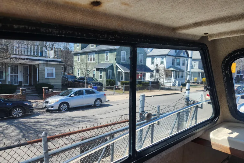 Slide: The Image of View from inside a 2000 Austin Parker 2520 Cabin, overlooking a residential street. - 16