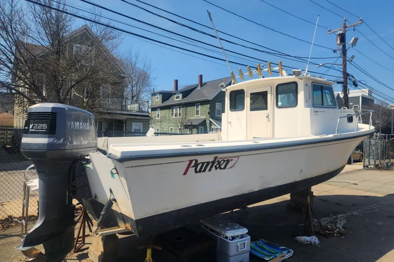 Slide: The Image of 2000 Austin Parker 2520 Cabin boat with Yamaha V225 engine on dry dock. - 2