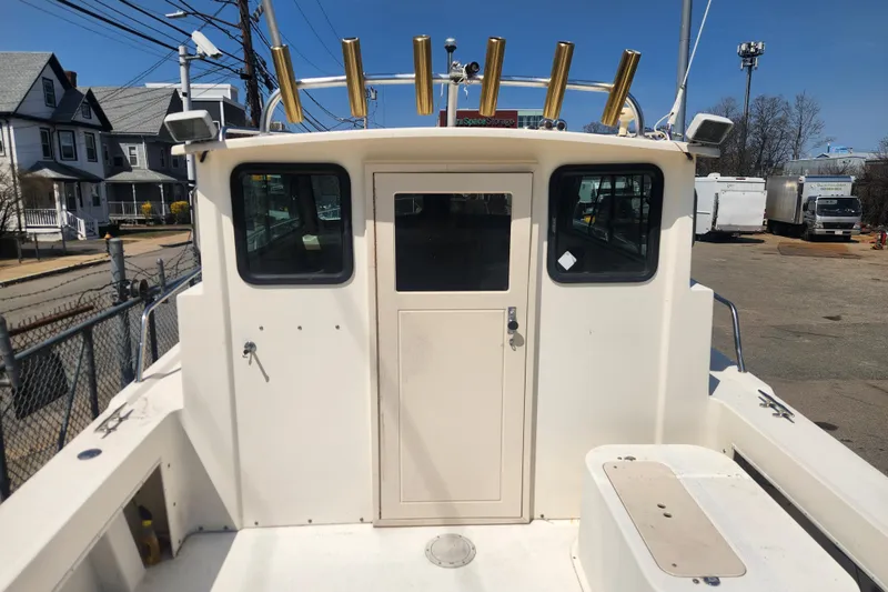 Slide: The Image of Austin Parker 2520 Cabin boat, rear view, docked in a marina, sunny day. - 5