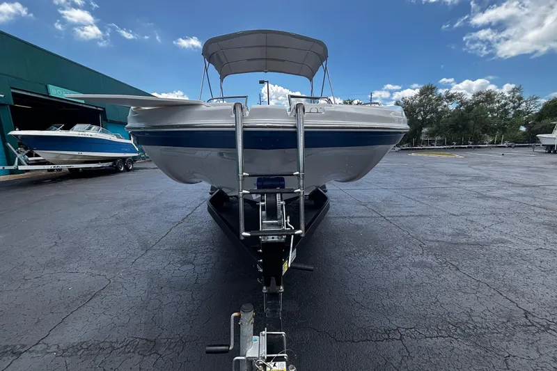 Slide: The Image of 2022 Hurricane SunDeck 217 OB boat on trailer under blue sky. - 4