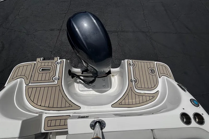 Slide: The Image of 2022 Hurricane SunDeck 217 OB boat with sleek outboard motor and stylish deck design. - 5