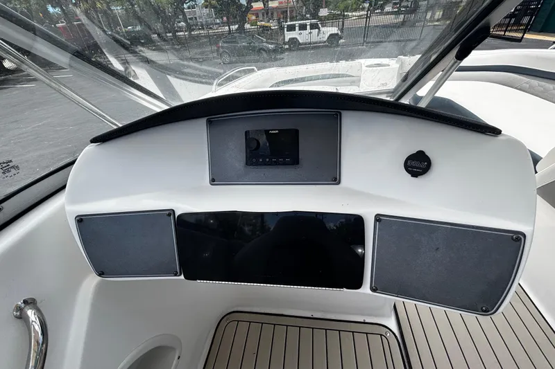 Slide: The Image of 2022 Hurricane SunDeck 217 OB boat dashboard with controls and steering wheel. - 7