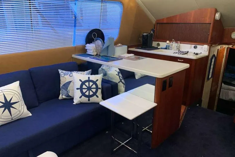 Slide: The Image of Interior of 1995 Ocean Yachts 42 Super Sport with nautical-themed decor and compact kitchen. - 12