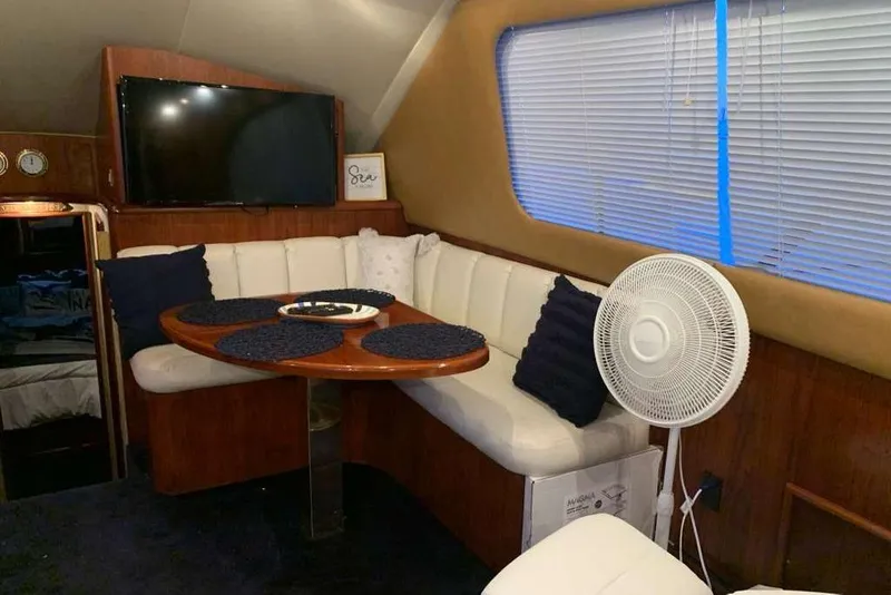 Slide: The Image of Luxurious interior of 1995 Ocean Yachts 42 Super Sport with dining area and TV. - 13