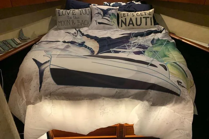 Slide: The Image of Cozy yacht-themed bedding in a 1995 Ocean Yachts 42 Super Sport cabin. - 14