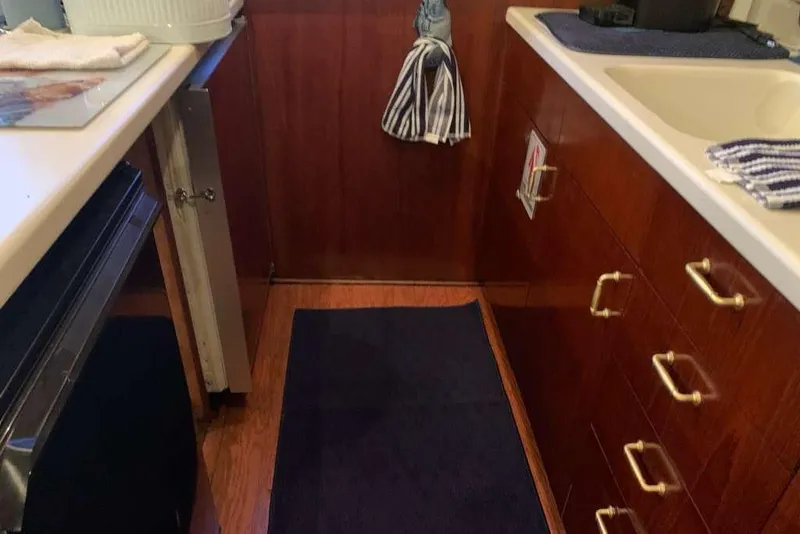 Slide: The Image of Galley kitchen in 1995 Ocean Yachts 42 Super Sport with wood cabinets and modern appliances. - 15