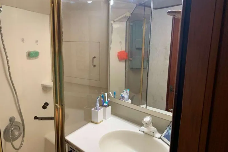 Slide: The Image of Bathroom interior of 1995 Ocean Yachts 42 Super Sport, featuring shower and sink area. - 17