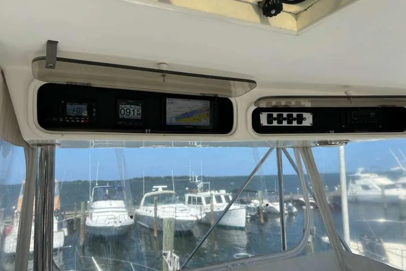 Slide: The Image of Interior view of a 1995 Ocean Yachts 42 Super Sport yacht dashboard with marina background. - 20