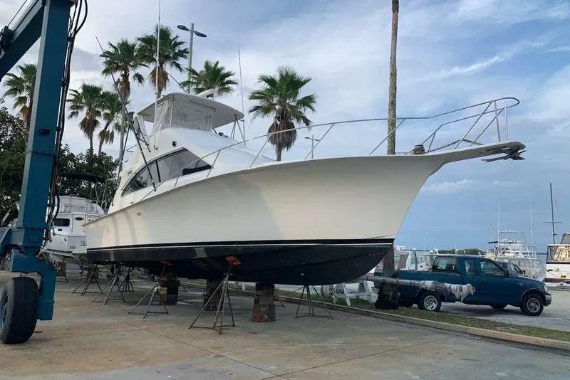 Slide: The Image of 1995 Ocean Yachts 42 Super Sport on dry dock with palm trees in background. - 21