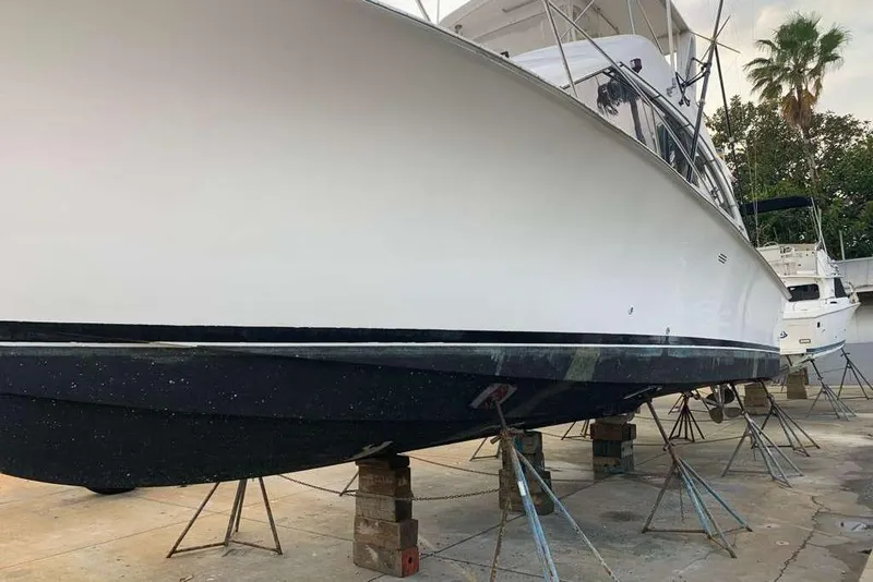 Slide: The Image of 1995 Ocean Yachts 42 Super Sport on dry dock, showcasing sleek hull design. - 22