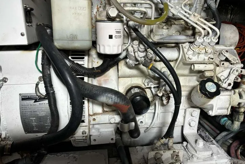 Slide: The Image of Engine compartment of a 1995 Ocean Yachts 42 Super Sport, showcasing mechanical components. - 28