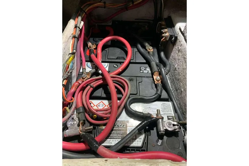 Slide: The Image of Battery compartment of a 1995 Ocean Yachts 42 Super Sport with red and black cables. - 34