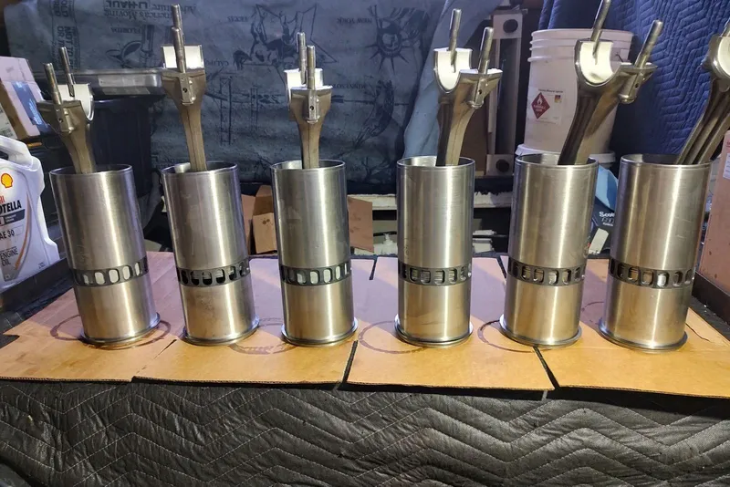 Slide: The Image of Six metal pistons with connecting rods from a 1995 Ocean Yachts 42 Super Sport engine. - 35