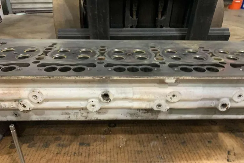 Slide: The Image of Engine cylinder head from a 1995 Ocean Yachts 42 Super Sport, displayed on a workshop table. - 37