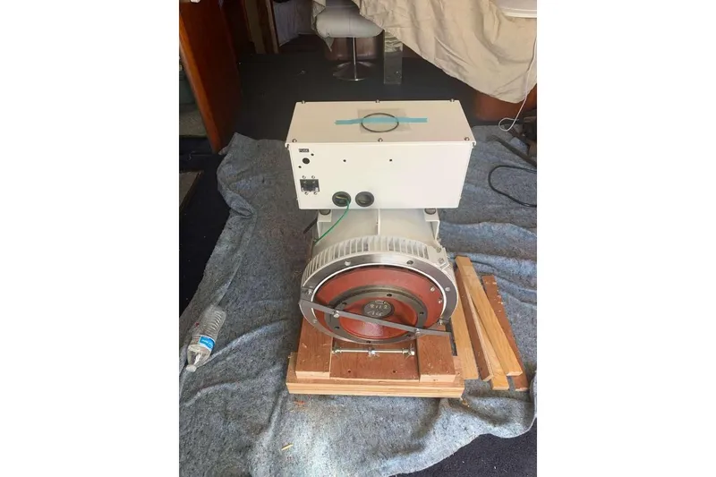 Slide: The Image of Generator inside 1995 Ocean Yachts 42 Super Sport, placed on a wooden platform. - 38