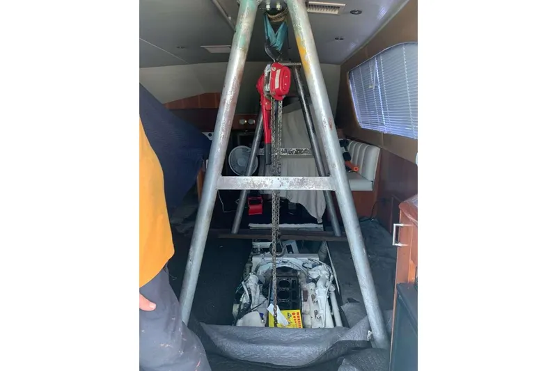 Slide: The Image of Engine maintenance inside 1995 Ocean Yachts 42 Super Sport, featuring hoist and interior view. - 39