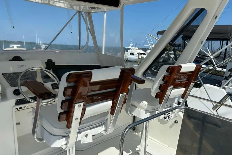 Slide: The Image of Cockpit of 1995 Ocean Yachts 42 Super Sport with wooden helm chairs and control panel. - 5