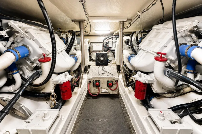 Slide: The Image of Engine room of a 1995 Ocean Yachts 42 Super Sport, showcasing dual engines and mechanical components. - 50