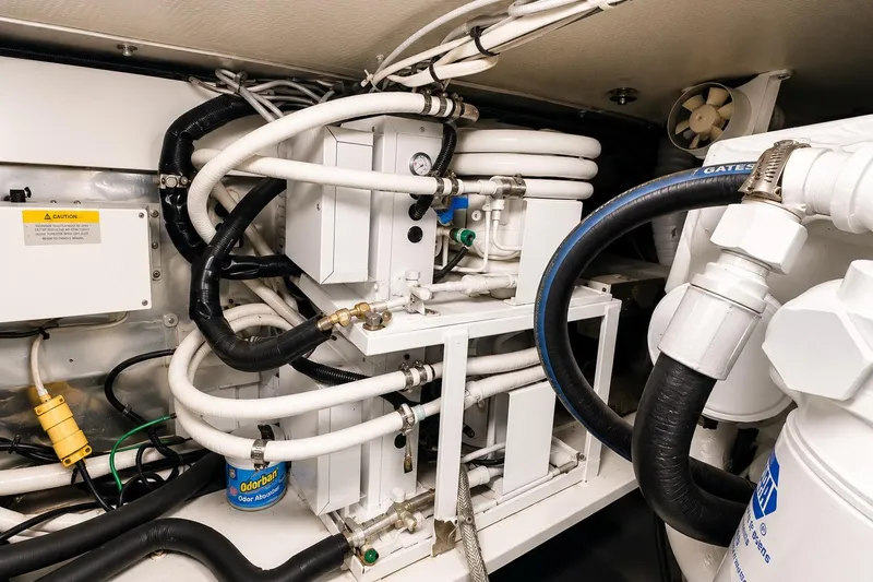Slide: The Image of Engine room of 1995 Ocean Yachts 42 Super Sport with complex piping and machinery. - 54