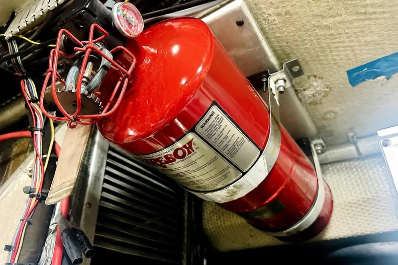 Slide: The Image of Fire extinguisher in 1995 Ocean Yachts 42 Super Sport engine room, surrounded by wiring. - 56