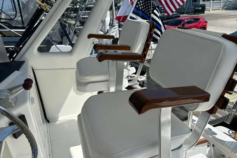 Slide: The Image of Captain's chairs on a 1995 Ocean Yachts 42 Super Sport, featuring sleek white and wood design. - 6